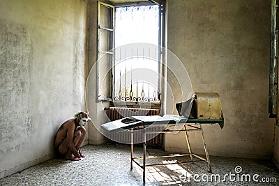 Crazy, scared man isolated abandoned in a madhouse in Italy Stock Photo