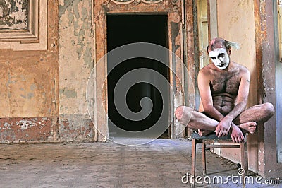 Alone crazy man naked in an abandoned house in Italy Stock Photo