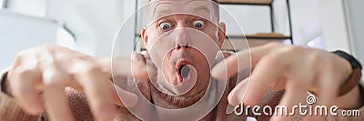 Crazy man with surprised facial expression types on keyboard Stock Photo