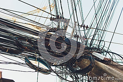 Crazy messy chaos wires cables on Electric poles. Stock Photo