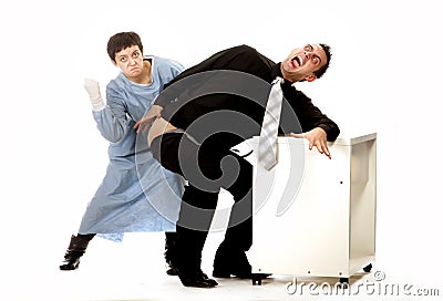 Crazy nurse giving injection to scared man Stock Photo