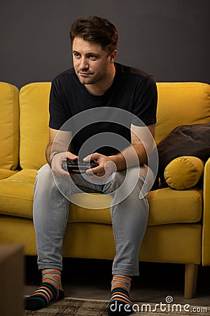 Crazy obsessed with games guy plays video game holding console gamepad in hands Stock Photo