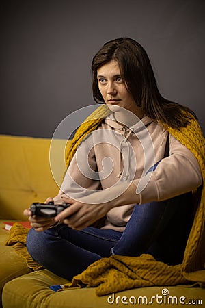 Crazy obsessed with games lady plays video game holding console gamepad in hands Stock Photo