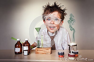 Crazy scientist. Young boy performing experiments Stock Photo