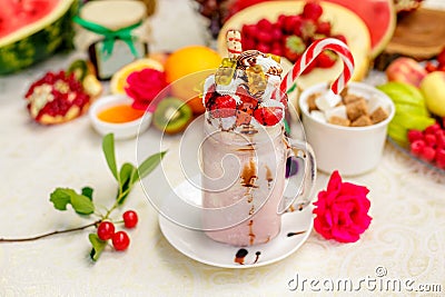 Crazy shake on top with a strawberry marmalade and candy and marmalade bears on a bright colored background Stock Photo