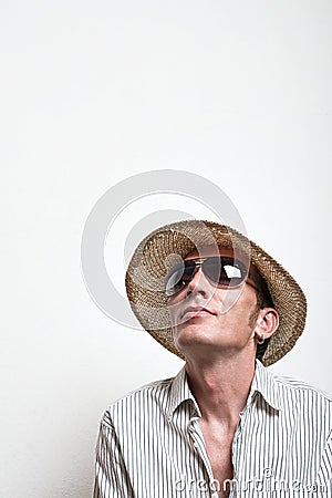 Crazy vacationer in straw hat and sunglasses dreaming Stock Photo