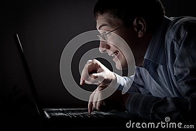 Crazy young adult man with laptop Stock Photo