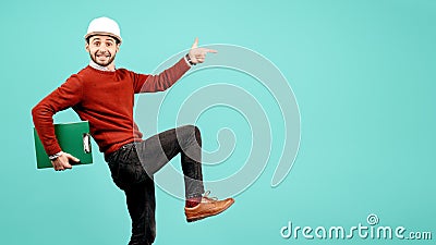 Crazy young handsome bearded engineer or constructor man in casual outfit point finger over cyan background Stock Photo