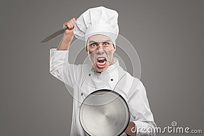 Enraged chef with knife and lid Stock Photo