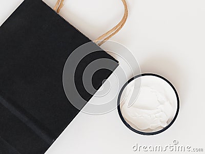 Cream for body or face and gift paper bag. Shopping Stock Photo