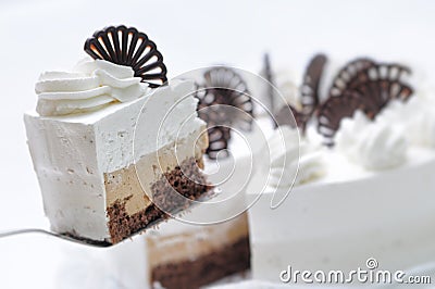 Cream cake on white plate, chocolate decoration with cake, patisserie, sweet tart with cocoa cream Stock Photo