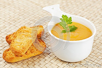 Cream of carrot soup and bread croutons Stock Photo