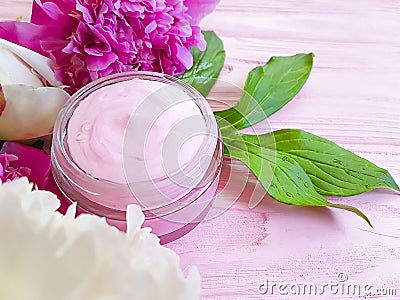 Cream cosmetic bloom peony moisturizing spring aromatherapy flower wooden background Stock Photo