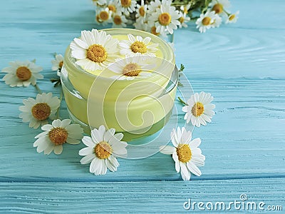 Cream cosmetic daisy chamomile product protection freshness extract on a blue wooden background Stock Photo