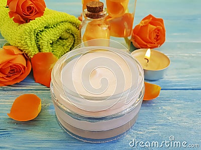 Cream cosmetic, extract, health rose towel spa moisturizing, on a blue wooden background, sensitive Stock Photo