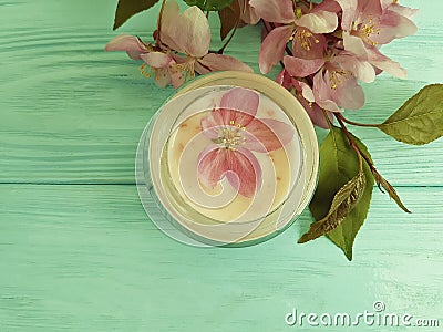 Cream cosmetic pink flowers on mint wood product scrub, handmade Stock Photo