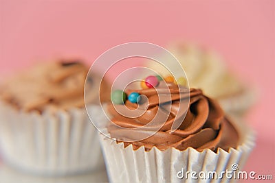 Cream cupcakes. White and black chocolate cakes on a pink background.Chocolate dessert. sweet table. Sweets and desserts Stock Photo