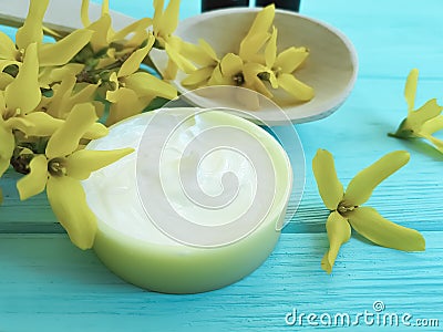 Cream product cosmetic skin extract natural care yellow ointment flowers on a wooden background Stock Photo