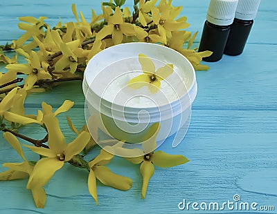 Cream product cosmetic yellow ointment flowers on a wooden background Stock Photo