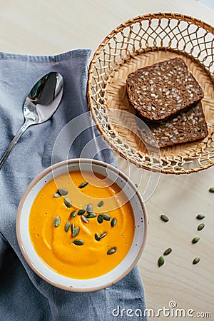 Cream of Pumpkin Soup with toasted bread and pumpkin seeds. Healthy homemade food. Natural food. Vegan diet. Stock Photo