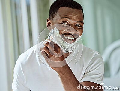 Cream, razor and shaving black man in the bathroom for skincare, beard grooming routine and facial care. Smile Stock Photo