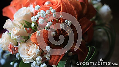 Cream roses,orange lilies and tiny white flowers,details of the wedding bouquet Stock Photo