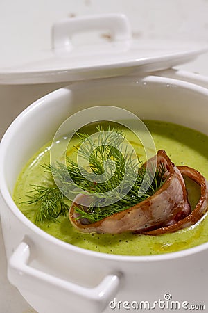 Cream soup with broccoli and grilled bacon flower . Stock Photo