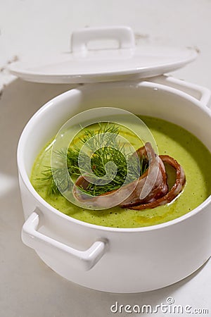 Cream soup with broccoli and grilled bacon flower . Stock Photo