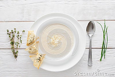 Cream-soup with cheese and bruschetta,white wood Stock Photo