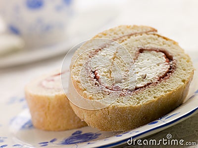 Cream and Strawberry Sponge Roll with Tea Stock Photo