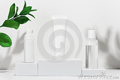 Cream tube, moisturizing foam in spray and tonic water on shipping boxes. White blank unbranded flacons with cosmetology products Stock Photo