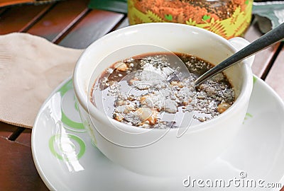 Creamer in cappuccino insoluble on the wooden floor background Stock Photo