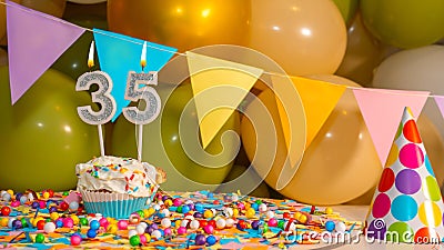 Creamy cupcake with candle for thirty five years, colorful happy birthday card for 35 year old, birthday cupcake with candles Stock Photo