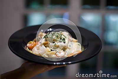 Creamy seafood, scallop and fish Fettuccine alfredo pasta dish Stock Photo