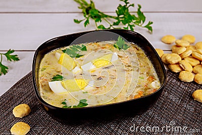 Creamy seafood soup with egg and crackers Stock Photo