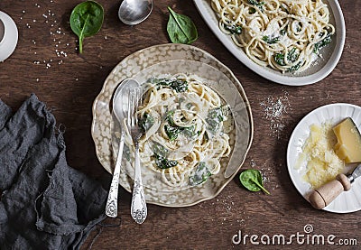 Creamy spinach spaghetti on wooden table, top view. Stock Photo