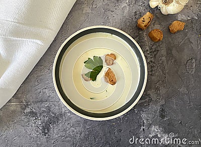 Vegetarian garlic cream soup with croutons and parsley. Stock Photo