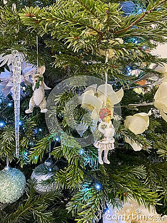 Creamy and white Christmas tree decorations: a girl and a rabbit. Close-up Editorial Stock Photo