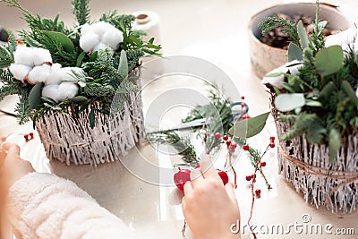 Creating Christmas floral arrangement with carnations, chrysanthemum santini flowers and fir Stock Photo