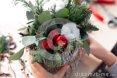 Creating Christmas floral arrangement with carnations, chrysanthemum santini flowers and fir Stock Photo