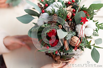 Creating Christmas floral arrangement with carnations, chrysanthemum santini flowers and fir Stock Photo