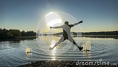 Creating dynamism with creative, energetic and enthusiastic movements by the sunrise lake Stock Photo