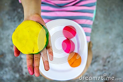 Colorful play dough on hand Stock Photo