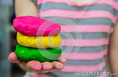 Colorful play dough on hand Stock Photo