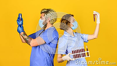 Creating vaccine. Medical professional workers colleagues. Doctors respirator mask. Infection vaccine and blood test Stock Photo