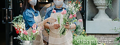 Creation of flower arrangement and modern service, owner teaches trainee Stock Photo