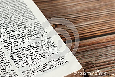 Creation of humanity verse in open holy bible on wooden table, Old Testament Genesis book Stock Photo