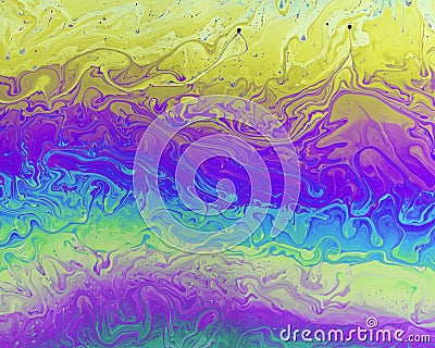 A creative abstract swirling liquid rainbow of colours that looks like watercolour paints or inks Stock Photo