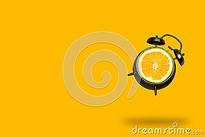 Creative art collage flying alarm clock with orange fruit slice on a orange background, summer bright poster Stock Photo