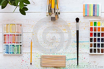 Creative art work accessories tools supplies set concept, paint brushes, paintbox with watercolors, crayons, pencils on white Stock Photo